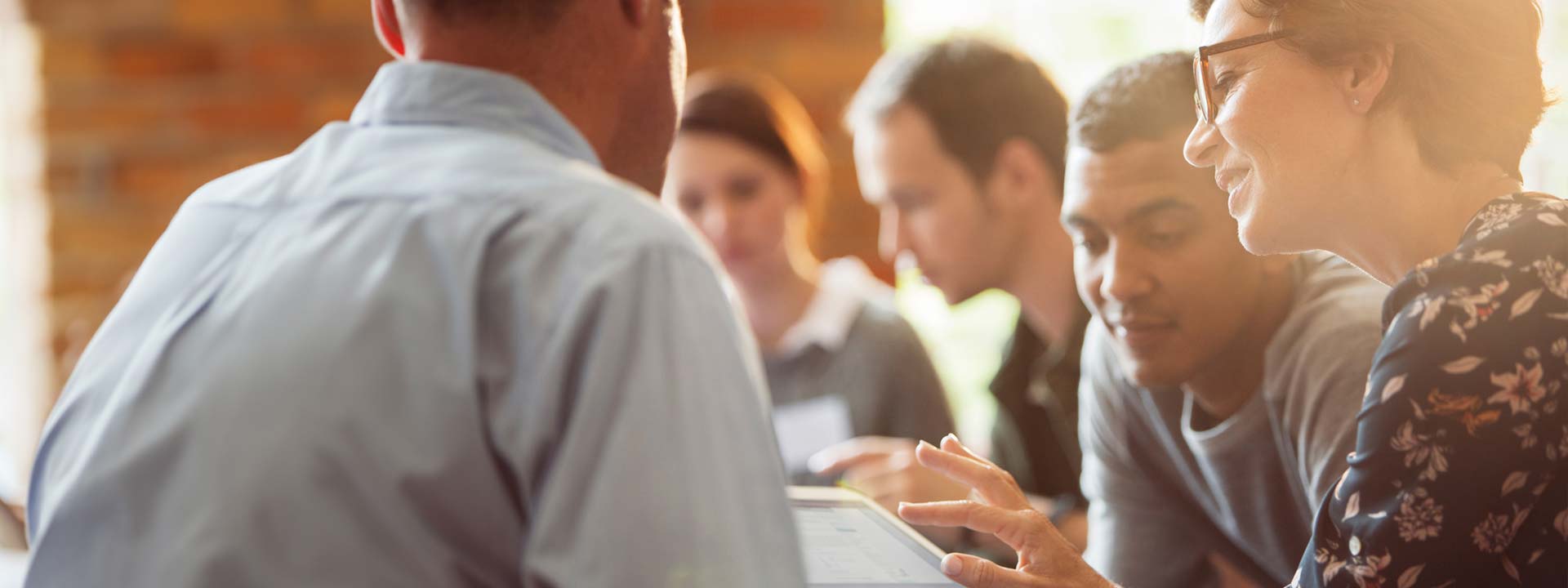 people talking and using tablets