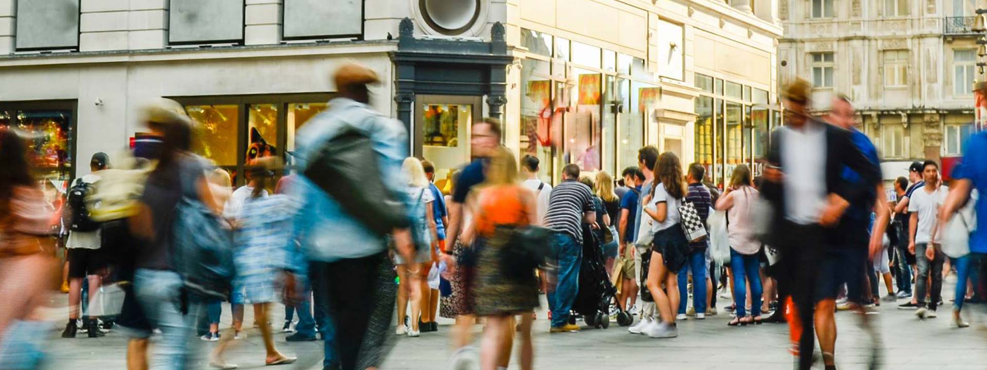 busy street with lots of people walking by blurred