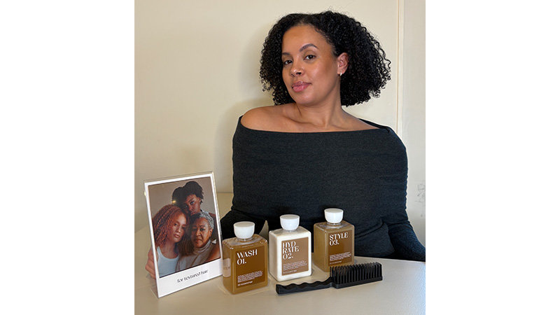 Alexandra Rydberg sitting smiling with products on the table