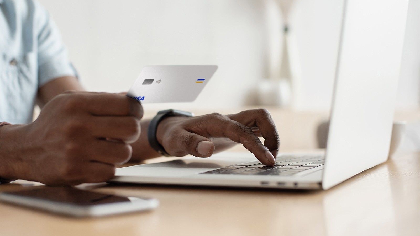 someone paying with their card on a laptop